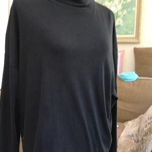 Black turtle neck . Machine launder do easy care.